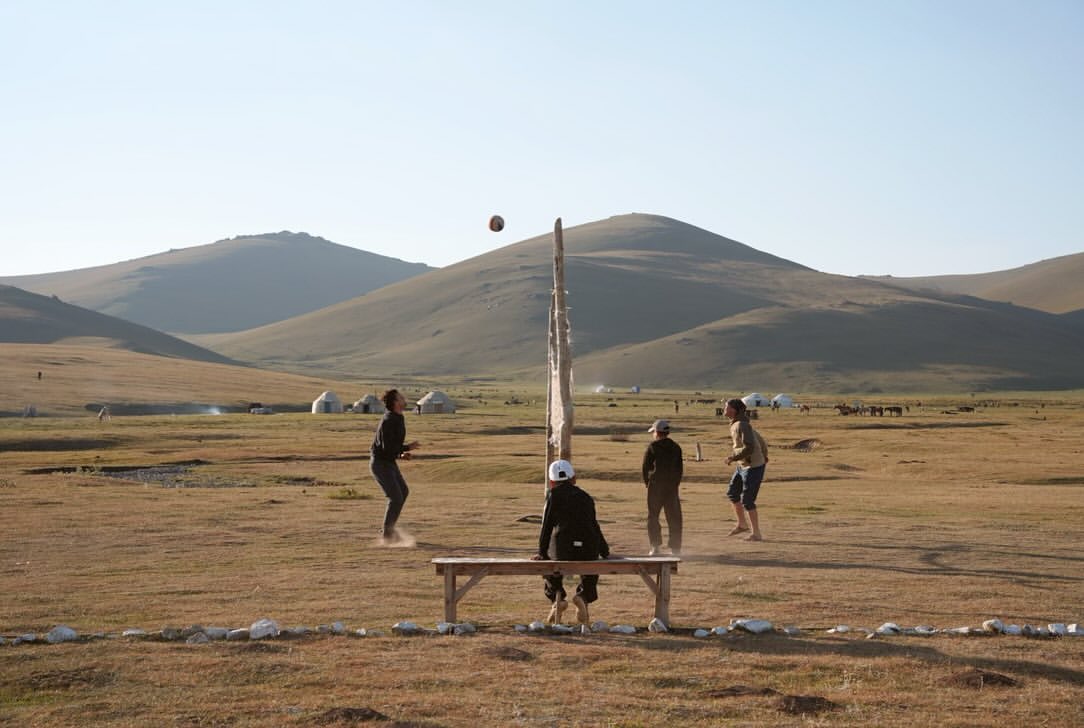 Guests playing a ball game at camp in the evening